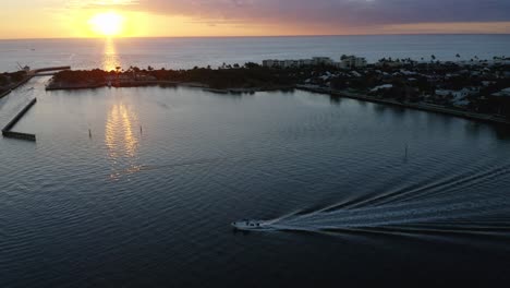 Sunrise-drone-panning-shot-of-boats-going-from-the-Intercoastal-Waterway-to-the-Atlantic-Ocean-at-Ocean-Inlet-Park-near-Boynton-Beach-Florida