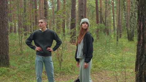 colleagues stand quietly among tall trees in tranquil forest, observing surroundings with thoughtful expressions and relaxed postures, during calm woodland exploration