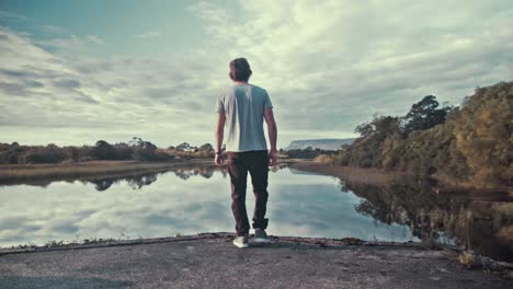 Young-man-walks-into-spectacular-river-view