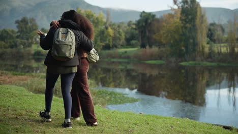 women, hug or walking by nature lake for camping