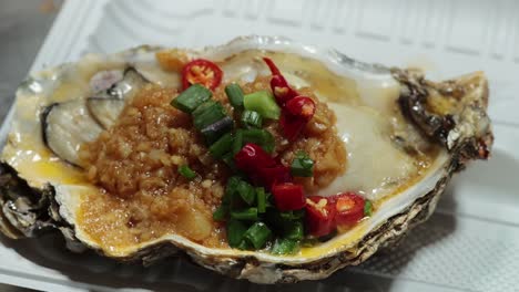 delicious grilled oyster with vibrant garnishes