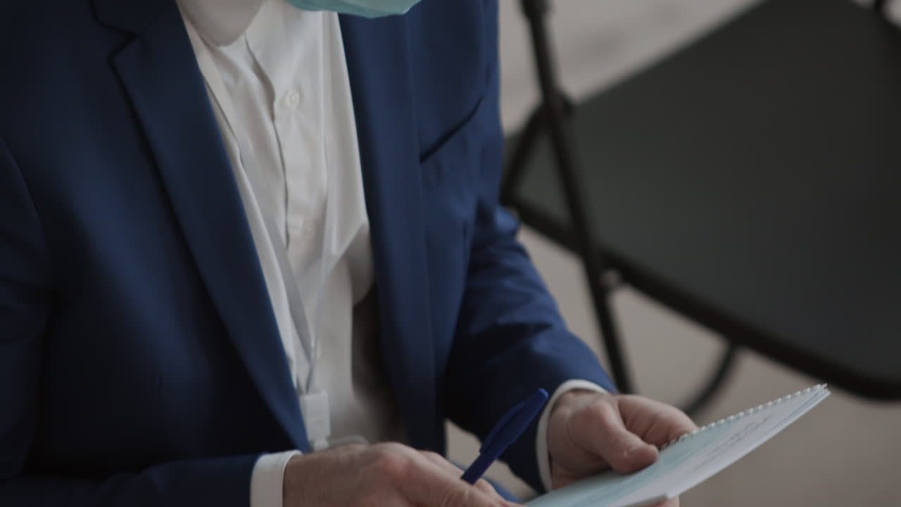 Businessman with Face Mask and Brochure
