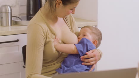 Young-Mother-Breastfeeding-Her-Baby-Boy-At-Home