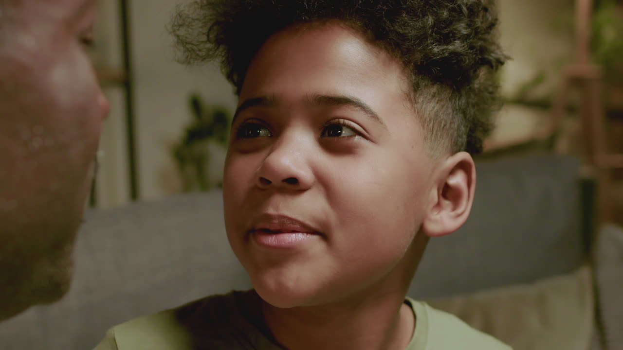 Old black man and boy talking at home