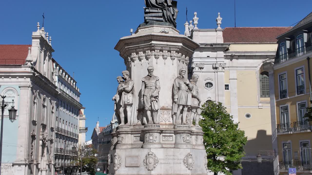 Majestic statue of Luis de Camoes, Portugal's most celebrated poet, dominating Lisbon's Praca Luis de Camoes under a clear blue sky