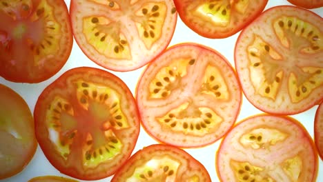 top view rotate of tomato slice on white background, close up fresh tomato sliced on white background and slowly rotating.