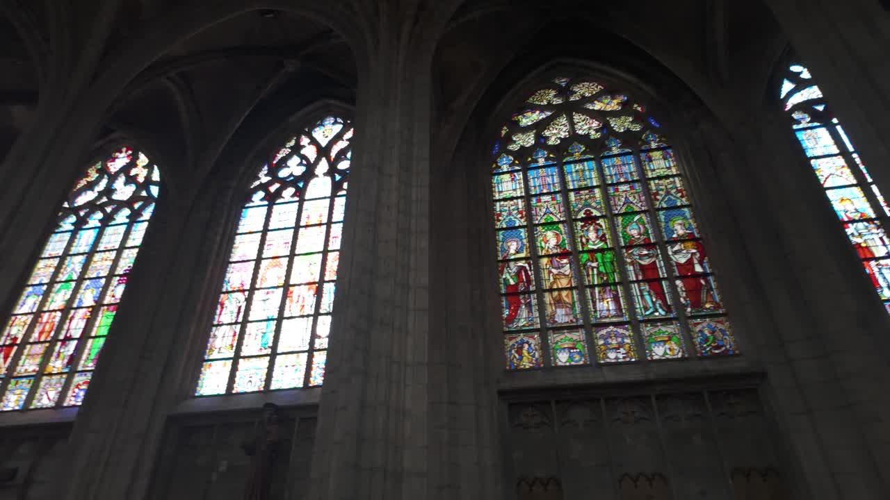 Stained glass windows inside Brussels' Church of Our Lady of Victories, serene mood