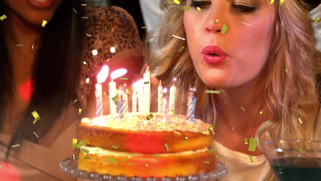 women blowing out her birthday candles