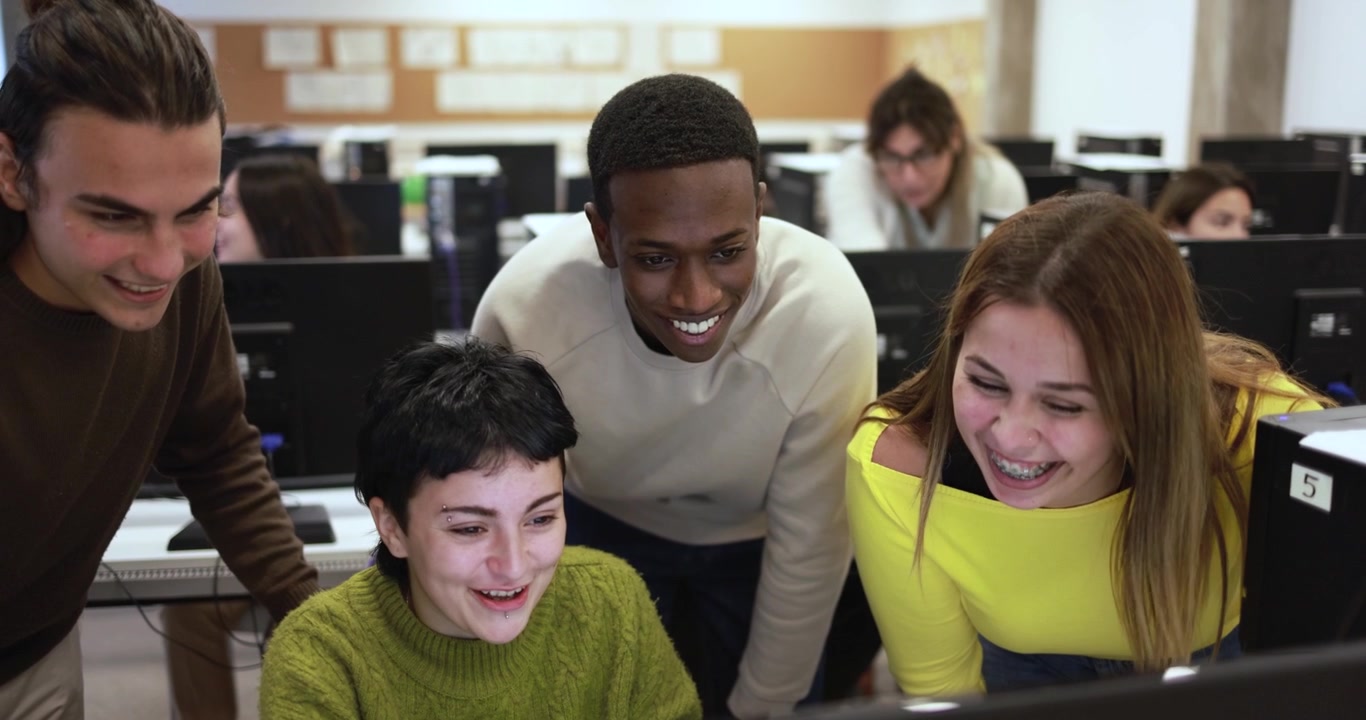 Diverse Group of Students Collaborating on Computer in Classroom