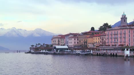 a beautiful small italian village of bellagio on the shores of lake como with the italian alps in background