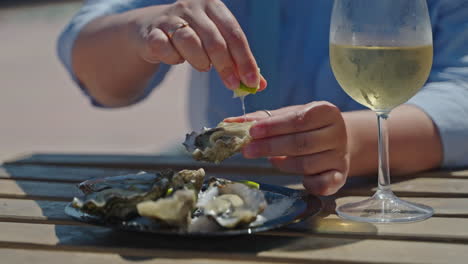 enjoying oysters with wine outdoors