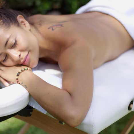 grinning woman resting on massage table