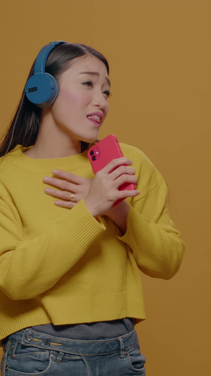 Woman singing with headphones and mobile phone