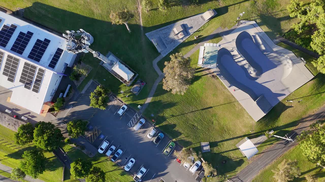Aerial footage captures dynamic skateboarding and scootering at a sunlit Gold Coast skate park