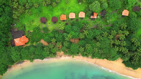 aerial rise view of the resort with bungalows on the beach and the turquoise sea. africa