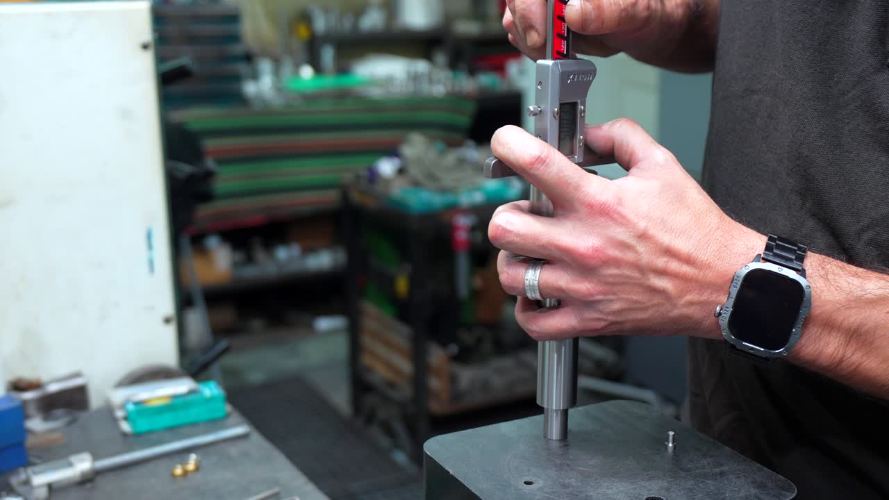 A man working with metal parts in a workshop