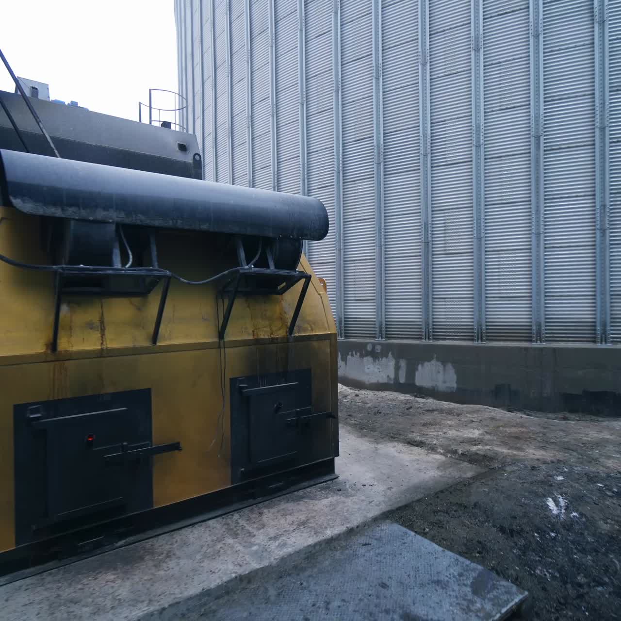 Going around the premises at modern elevator factory. Circle movement around the furnace buildings at granary. Quick motion