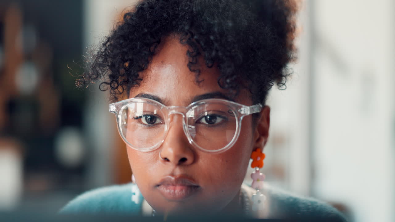 Close Up of Young Black Woman with Glasses Looking at Screen