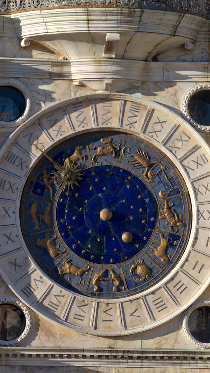 Close up view of the facade of The Clock Tower in St. Mark's Square. Vertical, Venice, Italy
