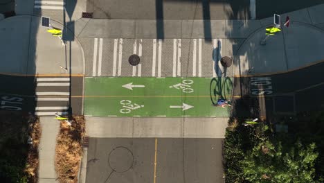 top down view of a cyclist passing through a vacant intersection using the bike lane