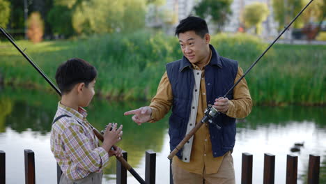 father and son fishing in park
