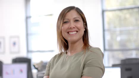 Portrait-of-happy-caucasian-casual-businesswoman-in-office,-slow-motion