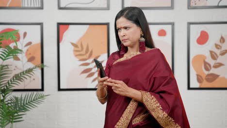 Serious-Indian-woman-talking-on-a-call