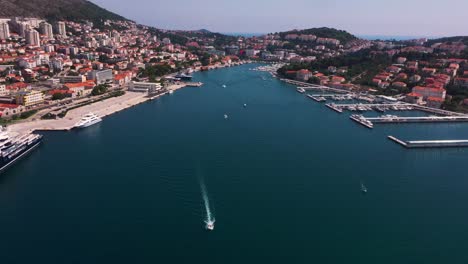 amazing static shot of harbour in dubrovnik, croatia with mountains, boats and crystal clear water in 4k