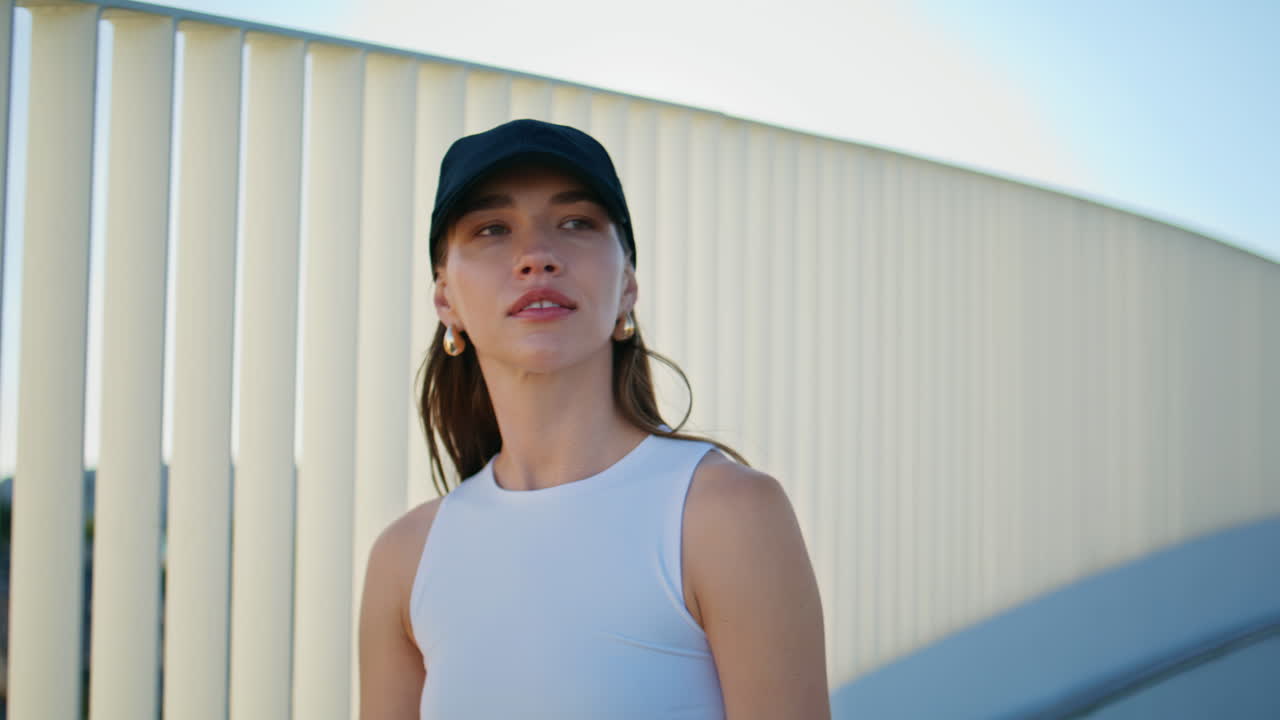 Relaxed woman athlete walking city area summer day closeup. Calm sportswoman