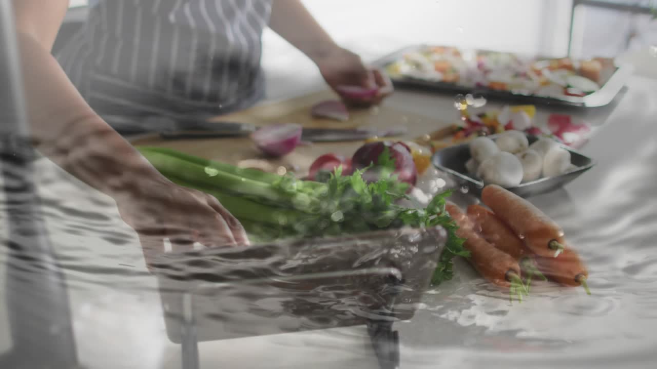 Woman slicing onion and checking tablet, causing ripple overlay intensifying for kitchen prep
