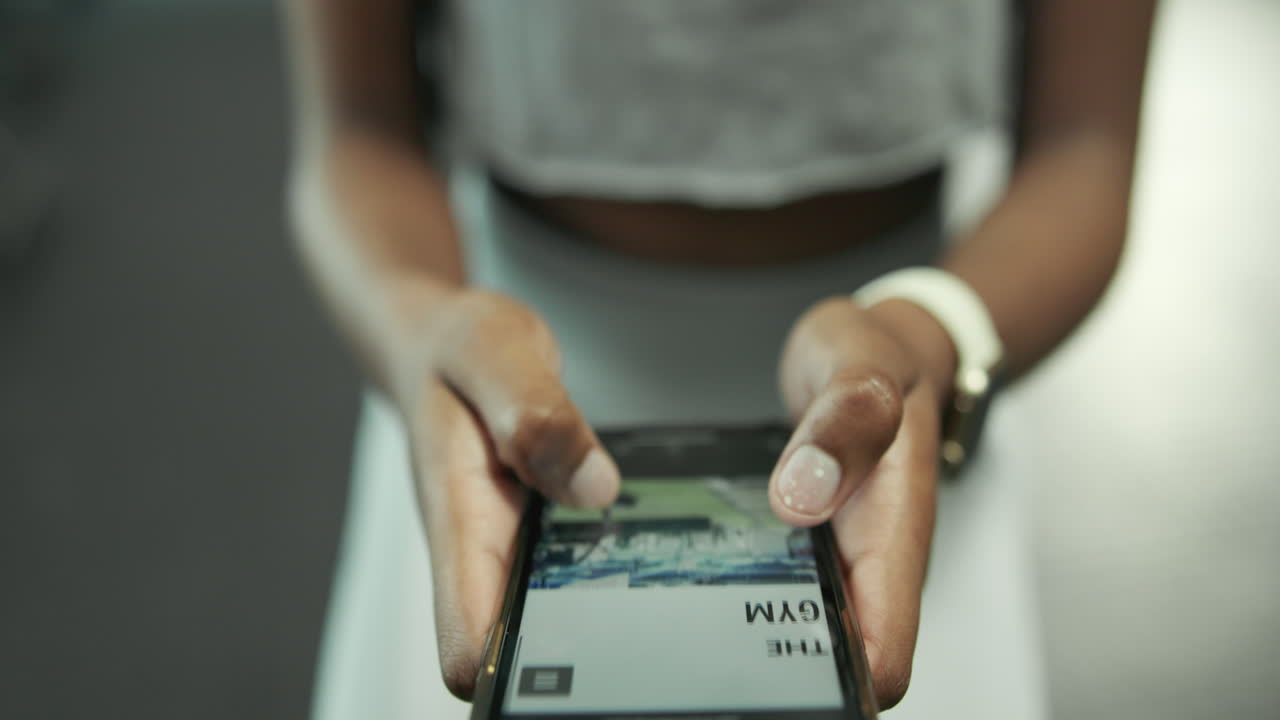 Woman using phone to book fitness class