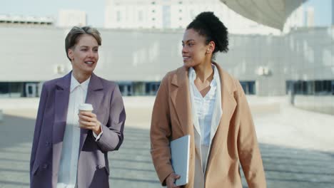 businesswomen having a conversation outside