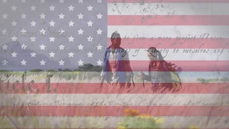 Animation-of-american-flag-and-text-moving-over-couple-hiking