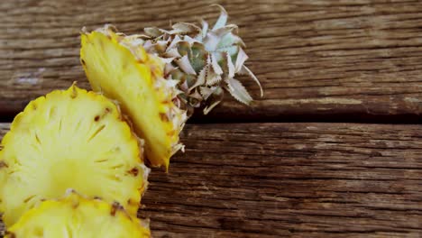 sliced pineapple on wooden plank