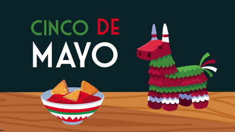 cinco de mayo lettering celebration with pinata and nachos in tomato sauce