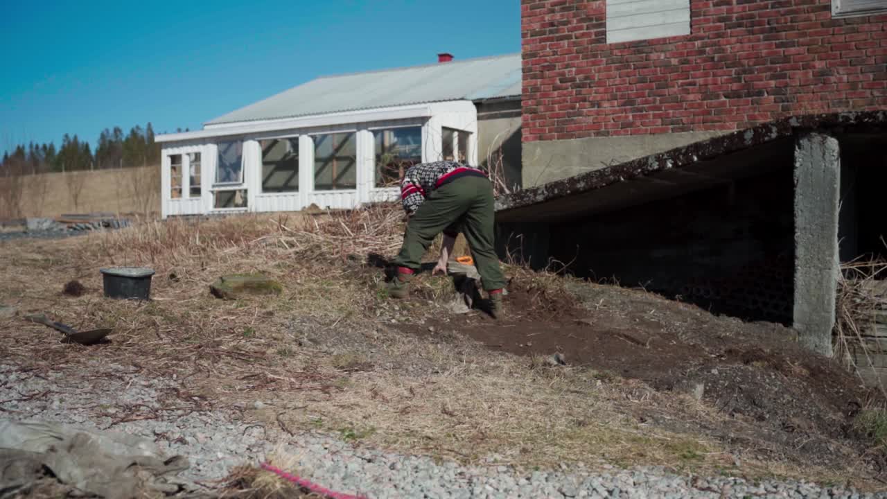 Timelapse Of a Man Leveling Ground With A Shovel