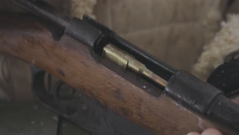 loading bullet in vintage riffle in battle world war one