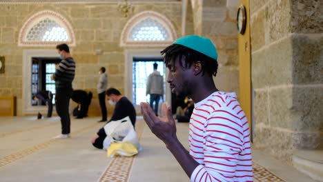 african young worship in mosque