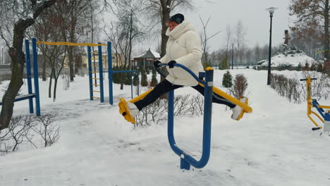 senior caucasian woman practicing on the simulator on the sport ground. healthy lifestyle in winter.