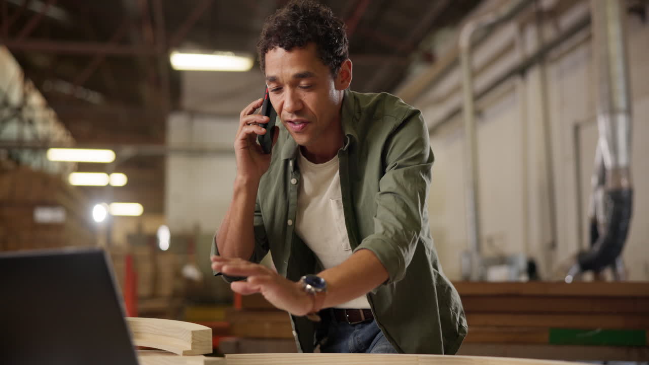 Man taking a phone call while woodworking