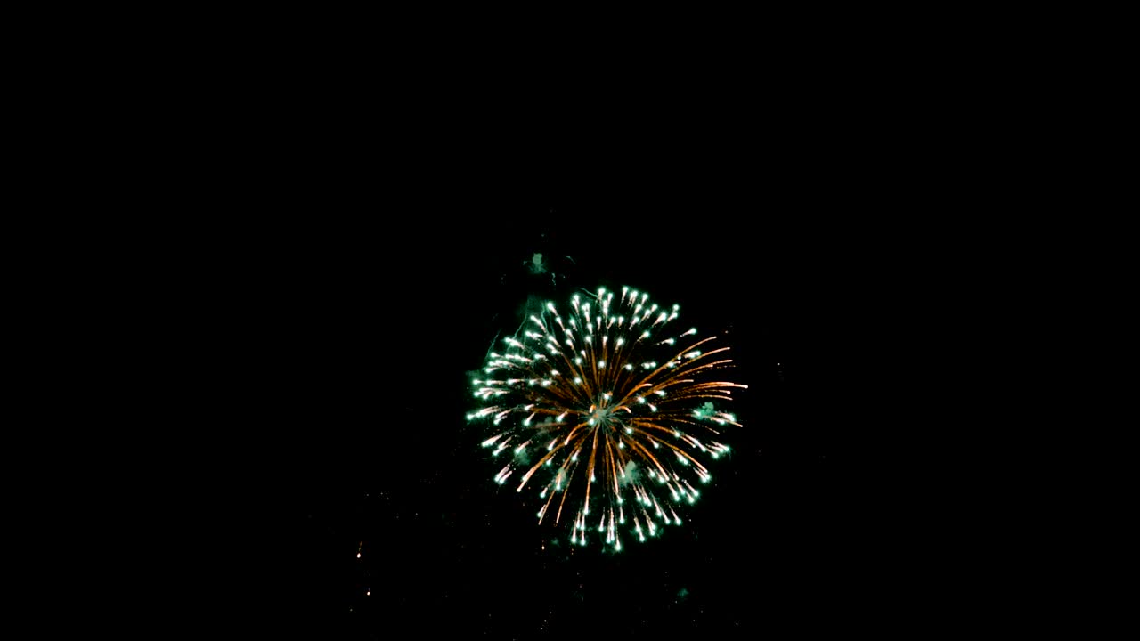 Celebration firework exploding and glow over dark background with dark and grain processed