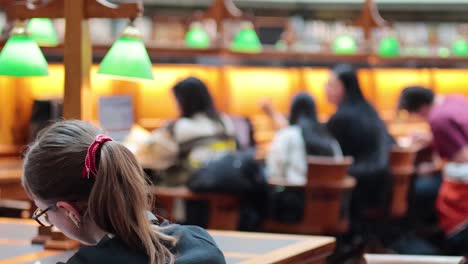 personas que leen y estudian en una biblioteca