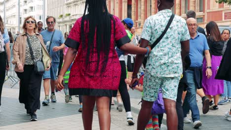 people walking and interacting outside museum entrance