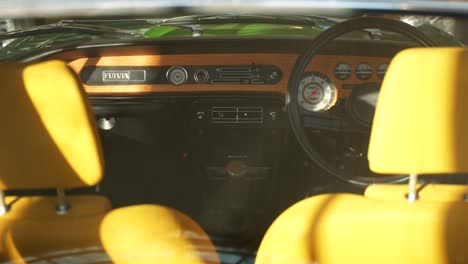 Italian-classic-car-interior,-with-yellow-seats-and-wooden-trim