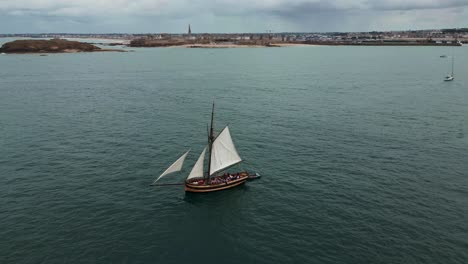 le renard wooden corsair ship sailing along saint-malo coast, france