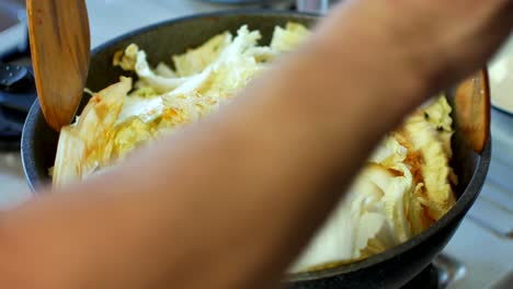 pov to the pot full of nappa cabbage while making korean food