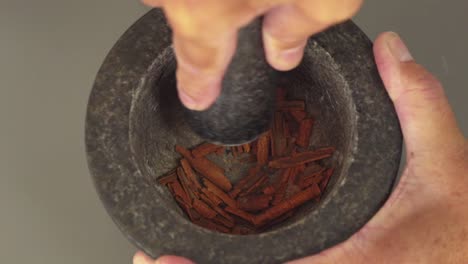 in this shot some natural plant extracts are being ground with a pestle and mortar to flavour homemade gin