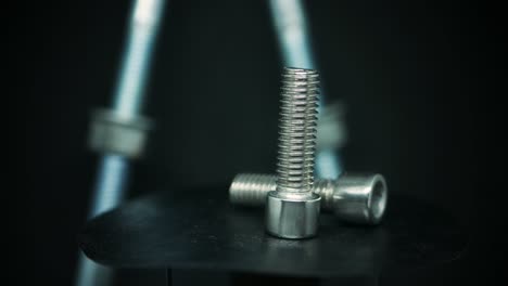 Allen-Key-Bolts-With-Hexagonal-Socket-Rotating-In-Blurry-Background---close-up,-selective-focus