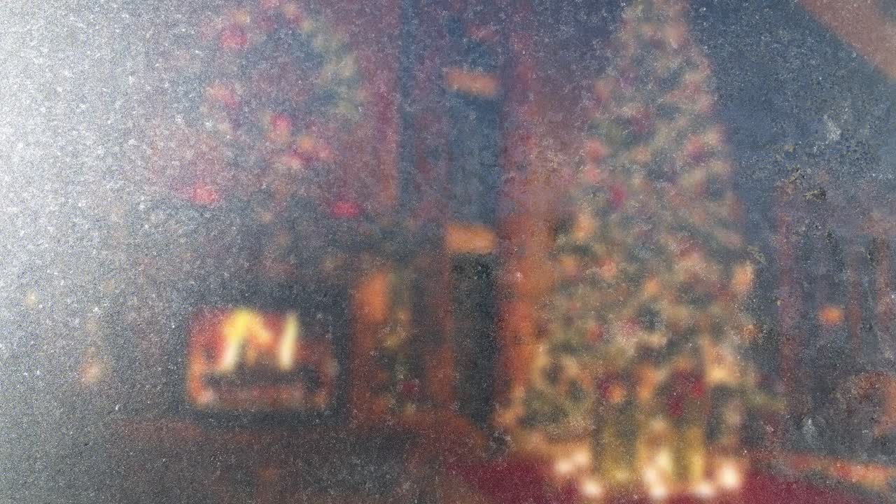 Frosty glass texture with blurred Christmas decor and fireplace. Warm and cold contrast for holiday videos. Seamless loop