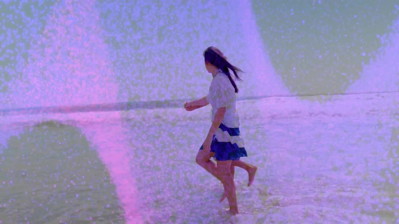 Two men stepping into surf, walking along shore for leisure travel, pink grain obscuring subjects